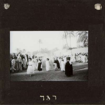 Lantern Slide: Group of children and nun in Christian street procession