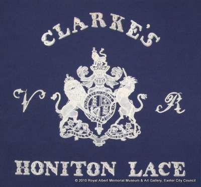Honiton (East Devon) lace, advertisement motif for Clarkes and the royal coat of arms