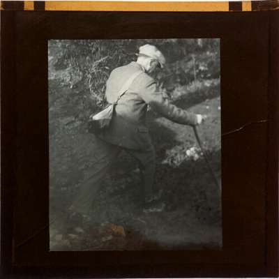 Lantern Slide: Photograph of man stepping across stream