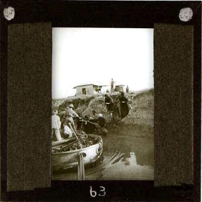 Lantern Slide: British soldiers taking items from local women at river bank