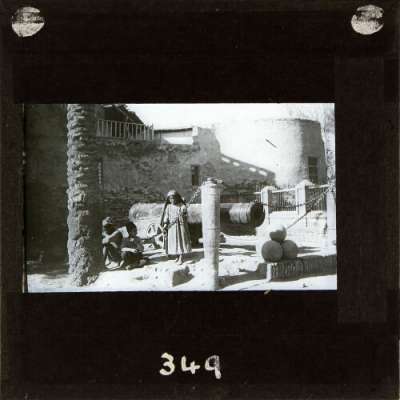 Lantern Slide: Group of children playing by cannon