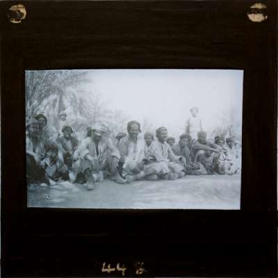 Lantern Slide: Group of seated men in local costume