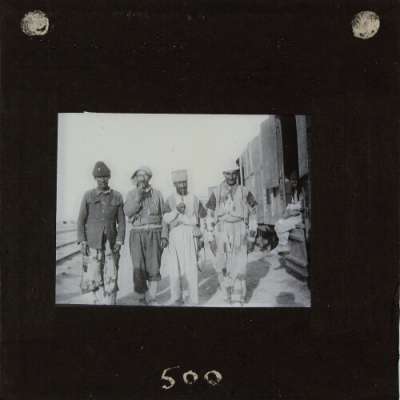 Lantern Slide: Group of four men standing by railway wagons