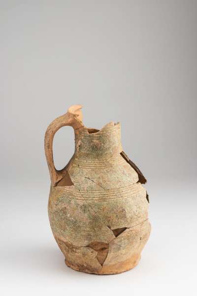 jug with slip and green glaze, rilled decoration